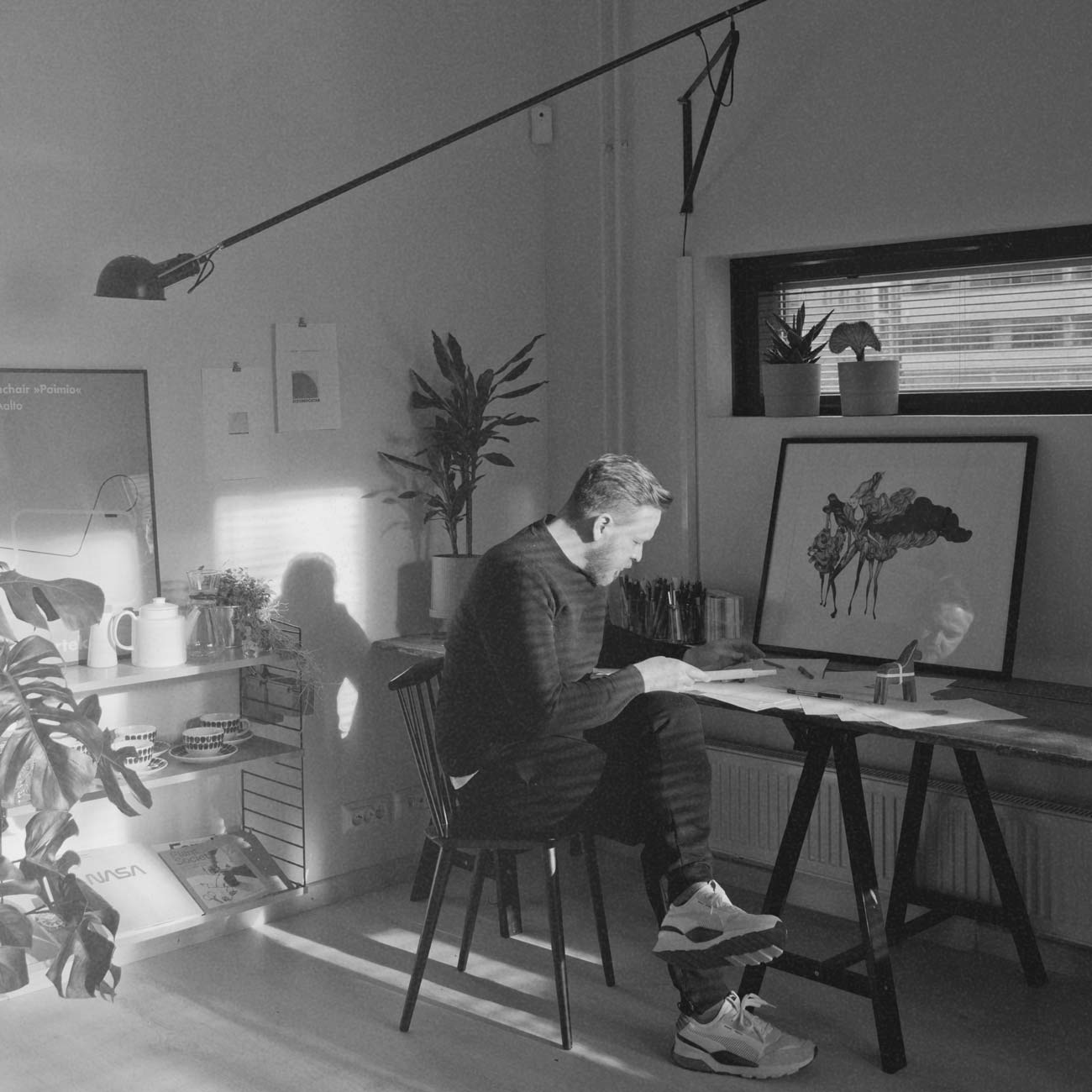 Herman Talvitie, founder of Designergatan, reviewing design sketches at his desk in the studio